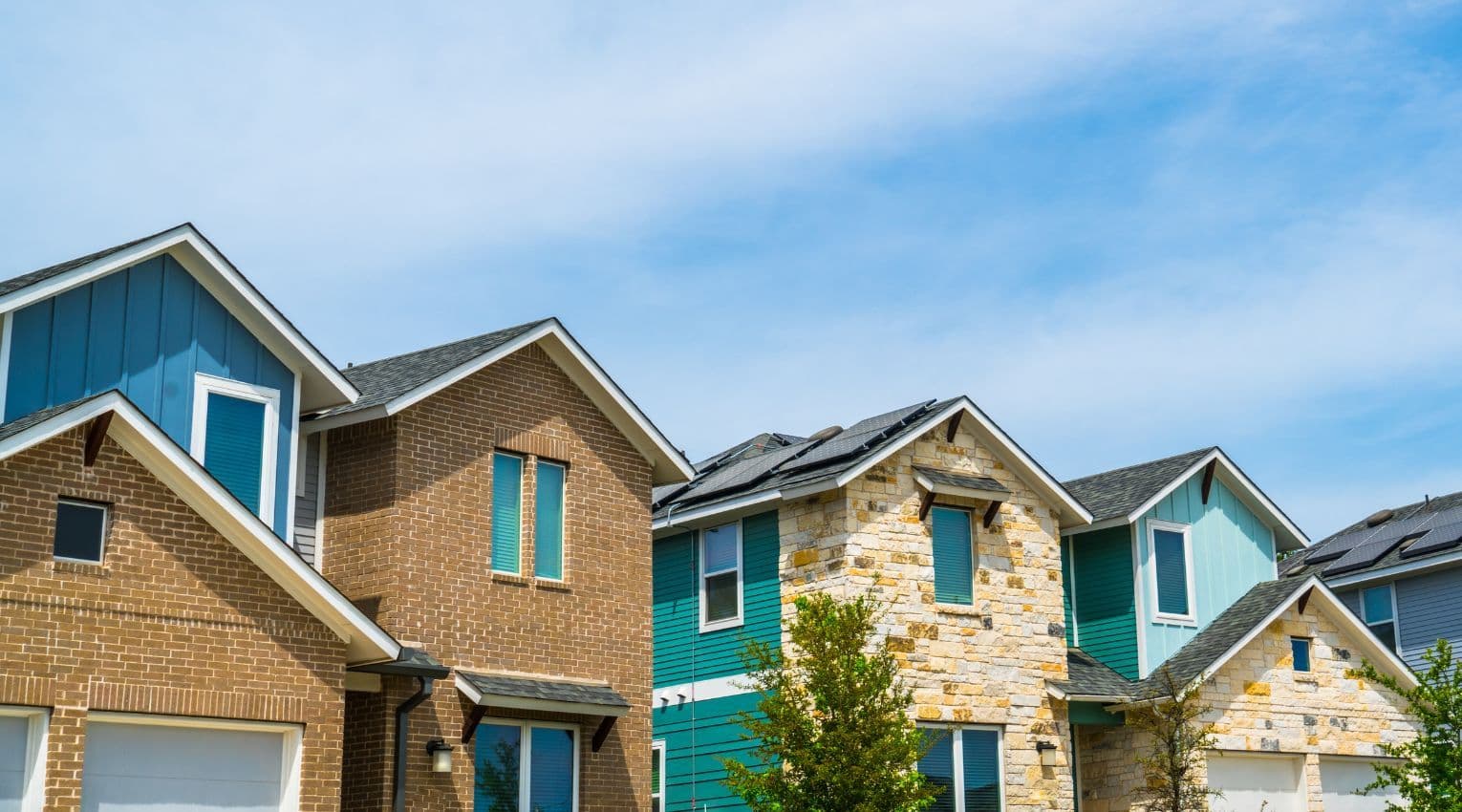 Roof lines of a row of suburban homes